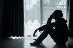 Person sitting alone in reflection, feeling weary and searching for hope