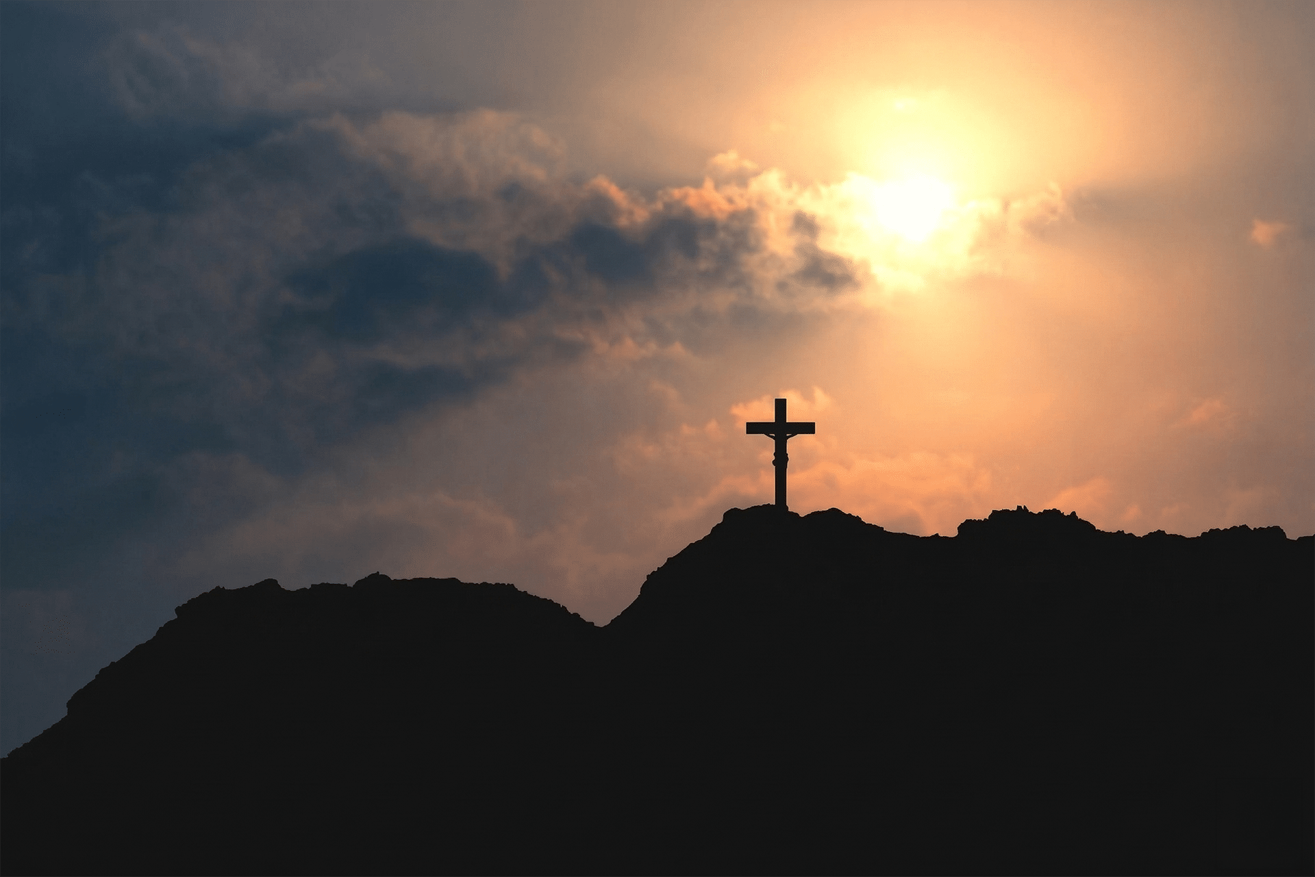 cross on a hill at sunset representing good friday and the crucifixion of jesus