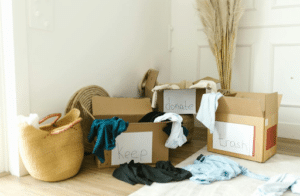 sorting clothes into boxes representing spiritual decluttering and repentance during Lent