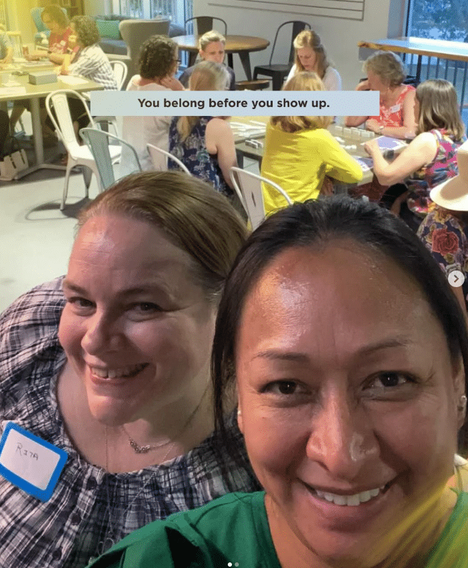 Women smiling during a small group gathering at Coker Methodist Church in San Antonio while others connect around tables in the background.